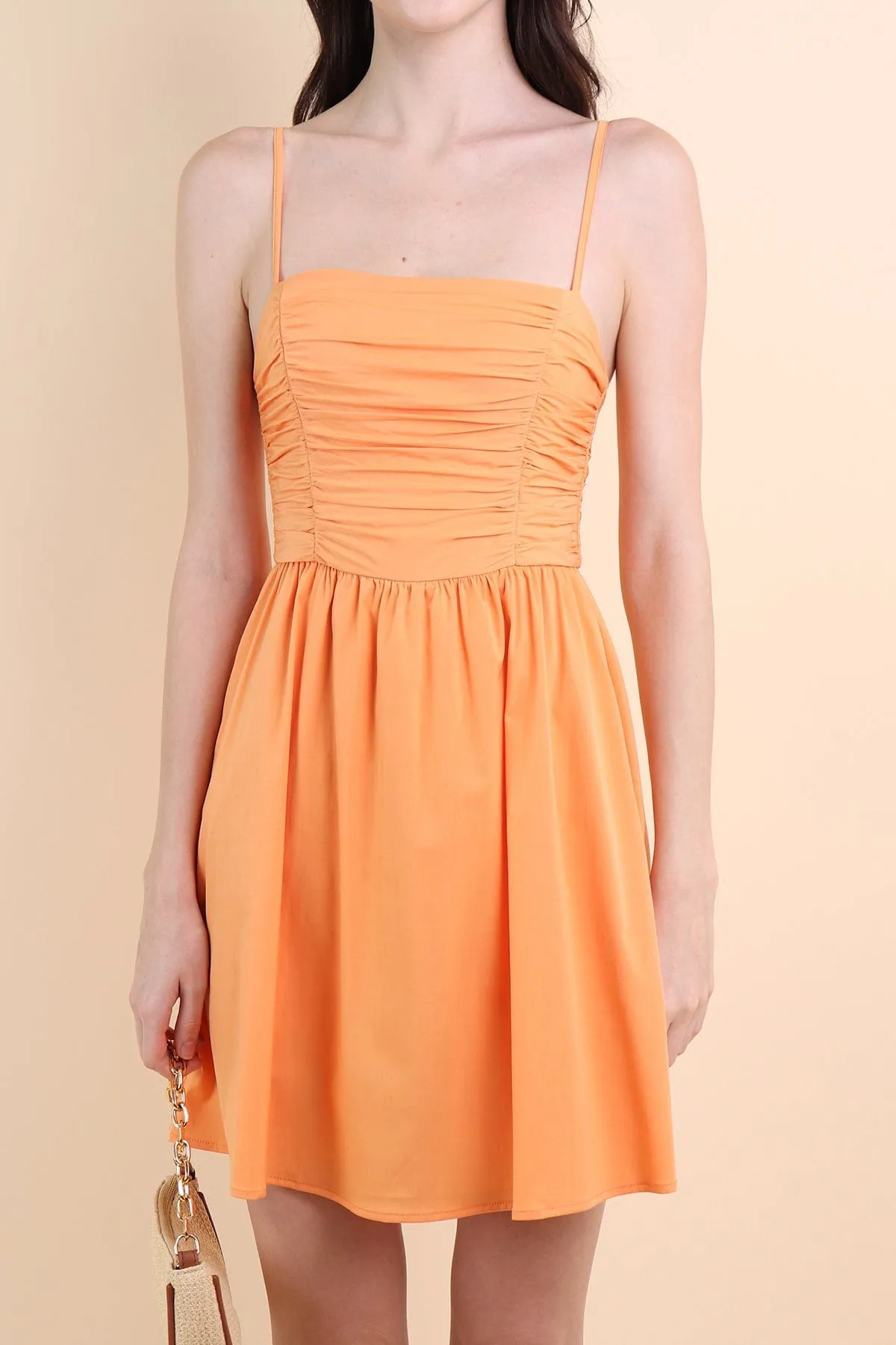 LOLA SLEEVELESS RUCHED ROMPER DRESS IN ORANGE