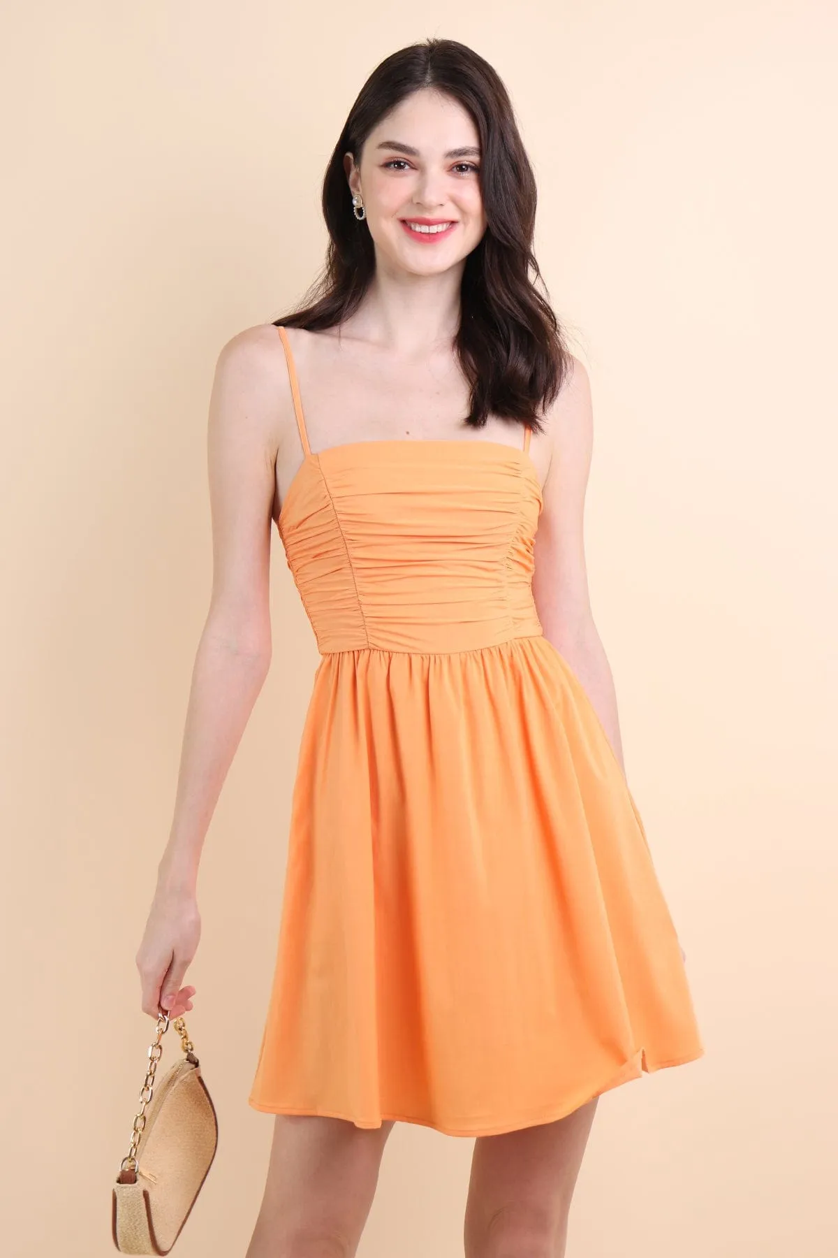 LOLA SLEEVELESS RUCHED ROMPER DRESS IN ORANGE