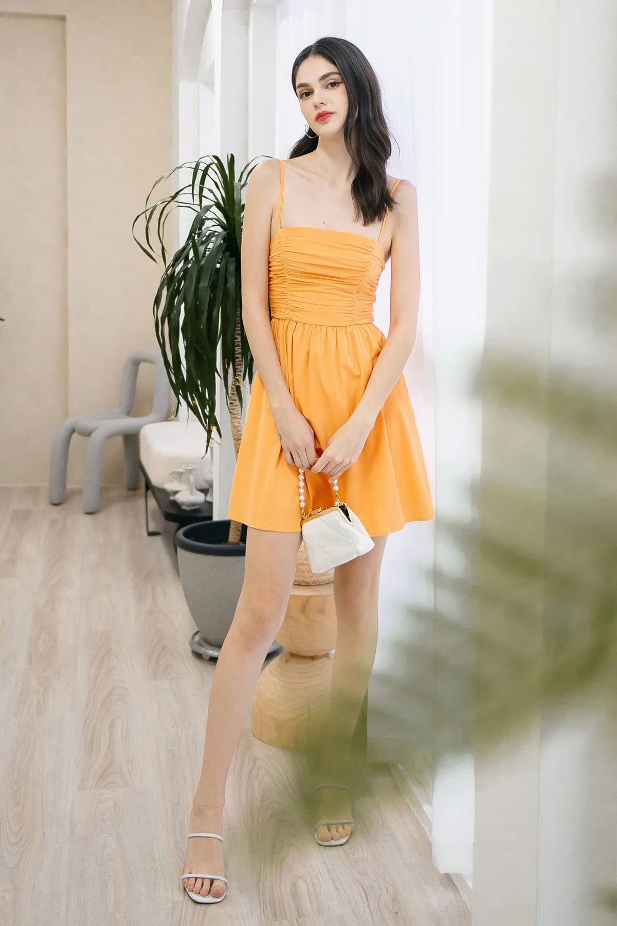 LOLA SLEEVELESS RUCHED ROMPER DRESS IN ORANGE