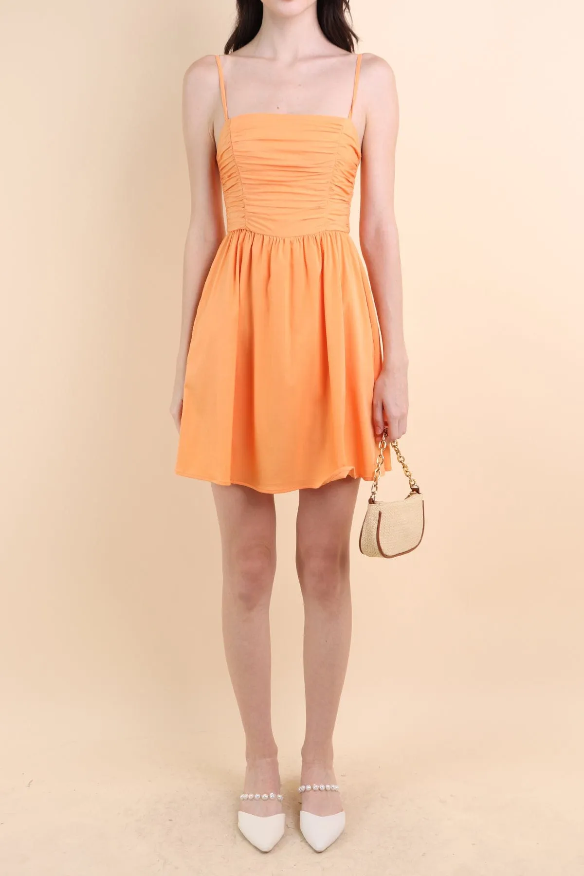 LOLA SLEEVELESS RUCHED ROMPER DRESS IN ORANGE