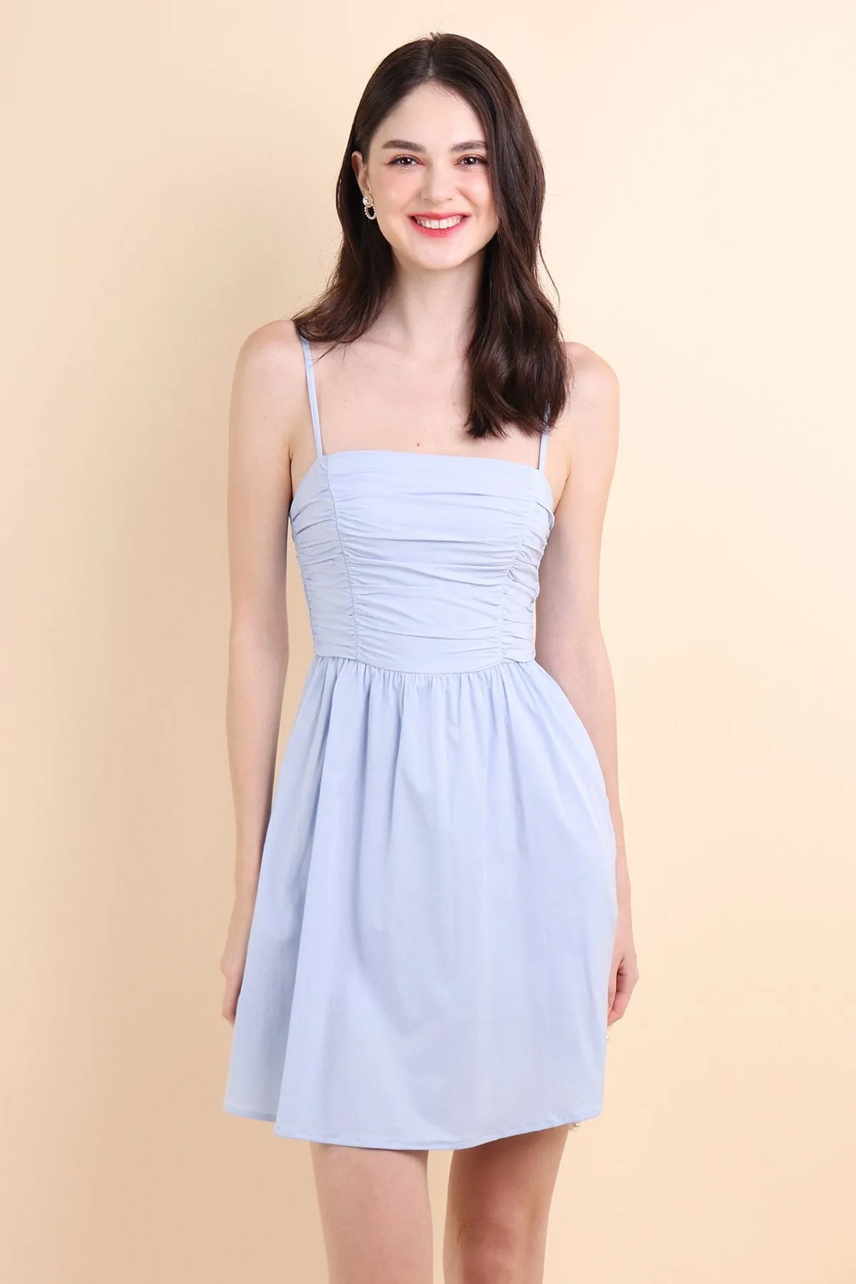 LOLA SLEEVELESS RUCHED ROMPER DRESS IN PERI BLUE